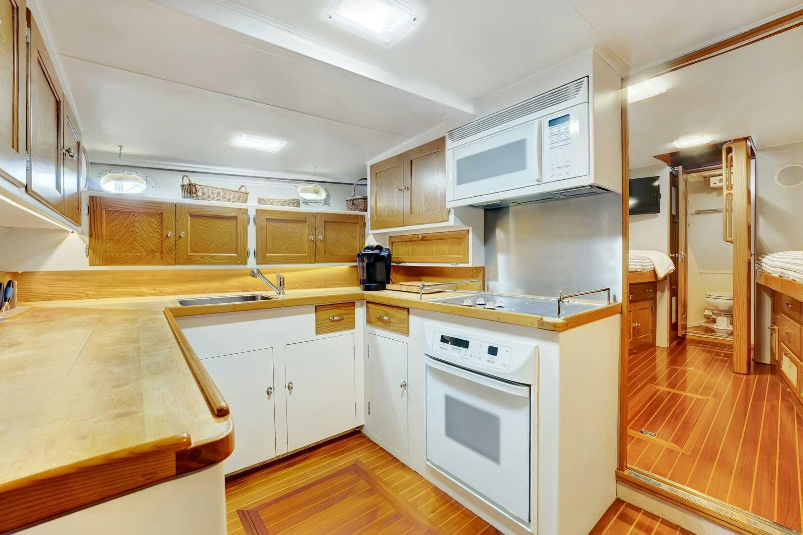 a kitchen with white cabinets aboard EAGLE Yacht for Sale