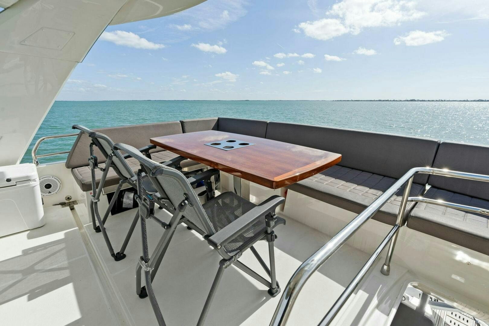 a table and chairs on a boat aboard PRESTIGE WORLDWIDE Yacht for Sale