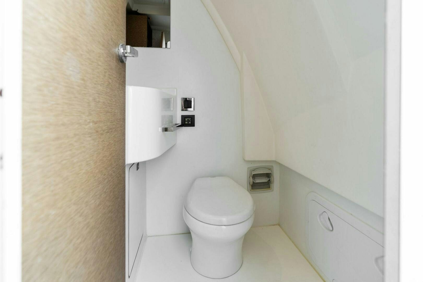 a toilet in a bathroom aboard PRESTIGE WORLDWIDE Yacht for Sale