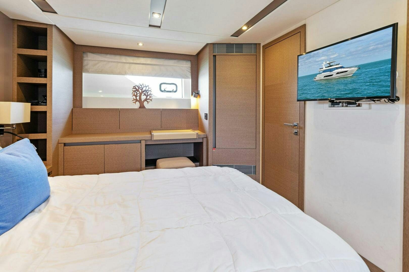 a bedroom with a bed and a television aboard PRESTIGE WORLDWIDE Yacht for Sale