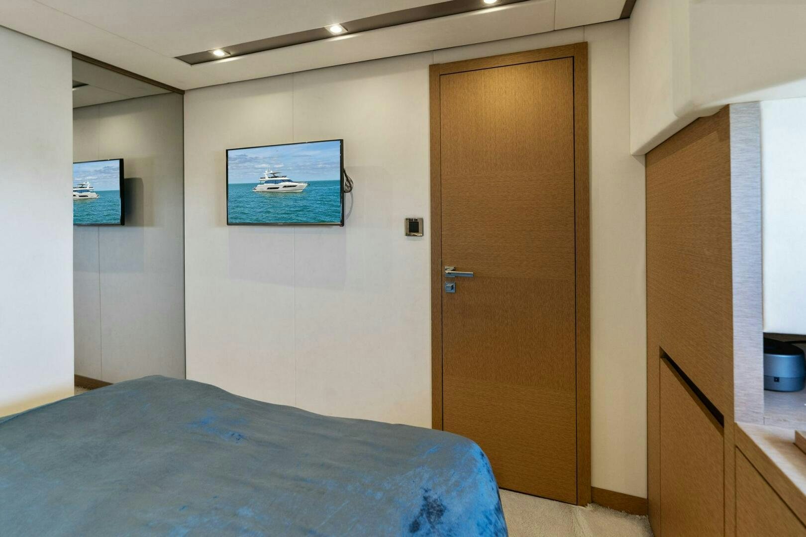 a bedroom with a bed and a television aboard PRESTIGE WORLDWIDE Yacht for Sale
