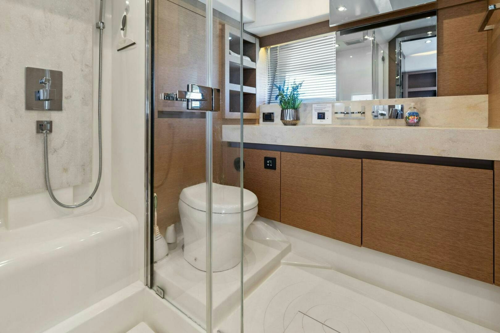 a bathroom with a glass shower aboard PRESTIGE WORLDWIDE Yacht for Sale