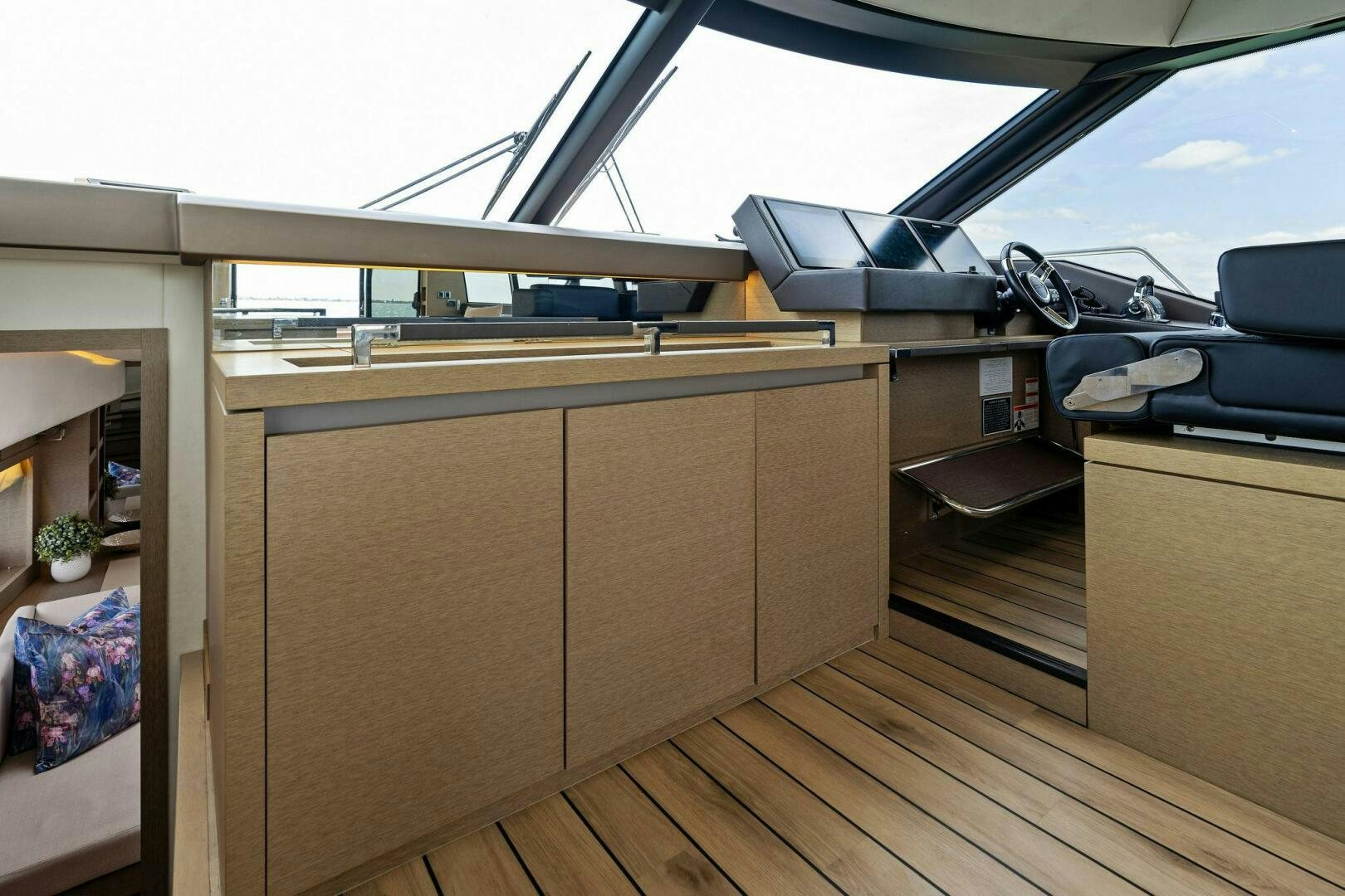 a room with a wood floor and a car parked in it aboard PRESTIGE WORLDWIDE Yacht for Sale