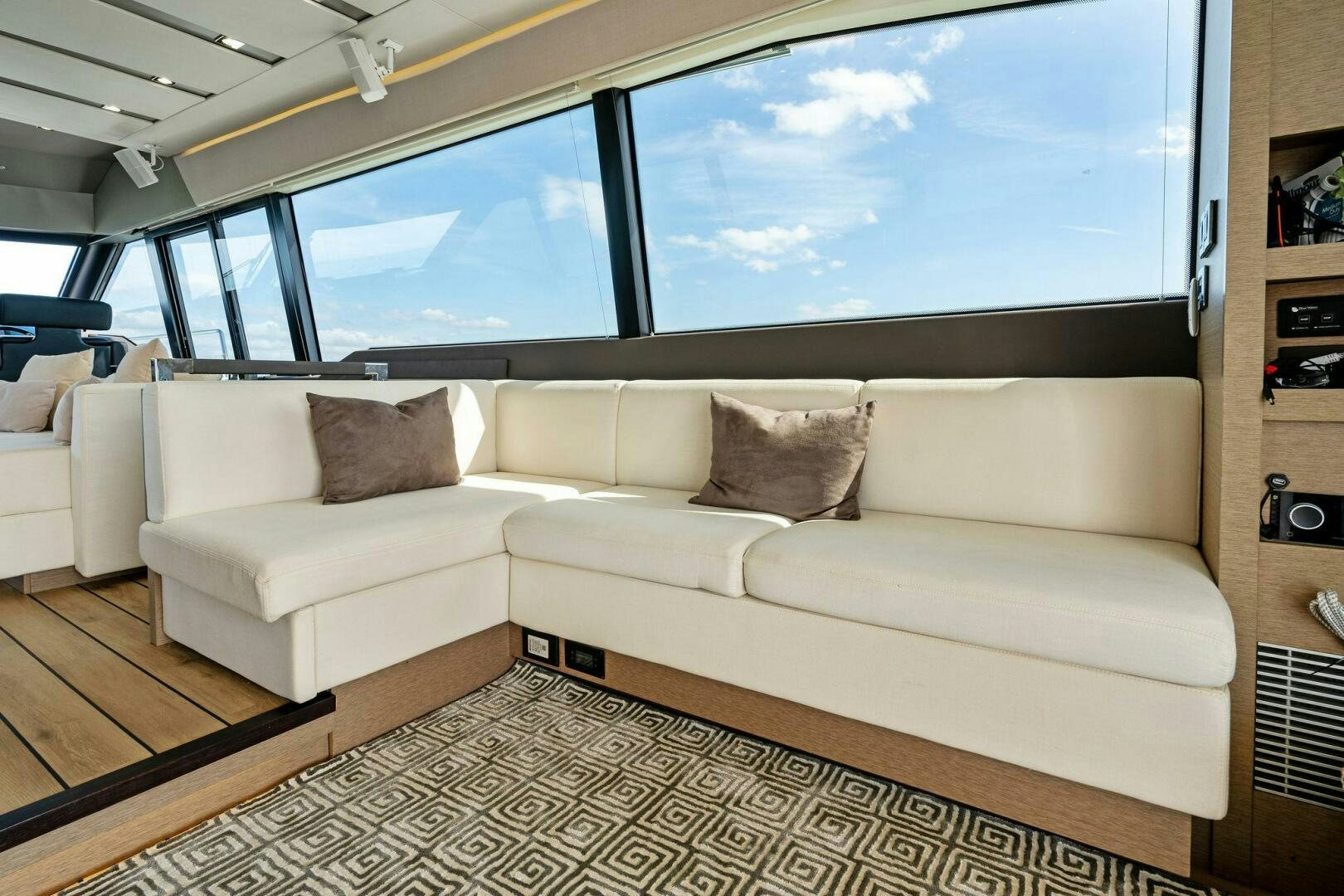 a living room with a large window aboard PRESTIGE WORLDWIDE Yacht for Sale