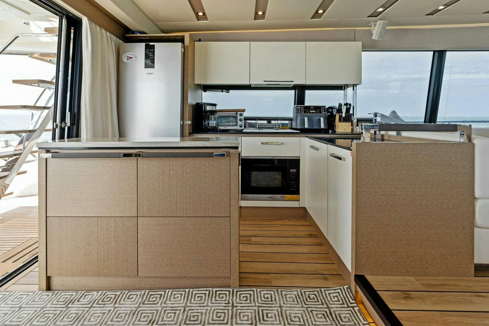 a kitchen with white cabinets aboard PRESTIGE WORLDWIDE Yacht for Sale
