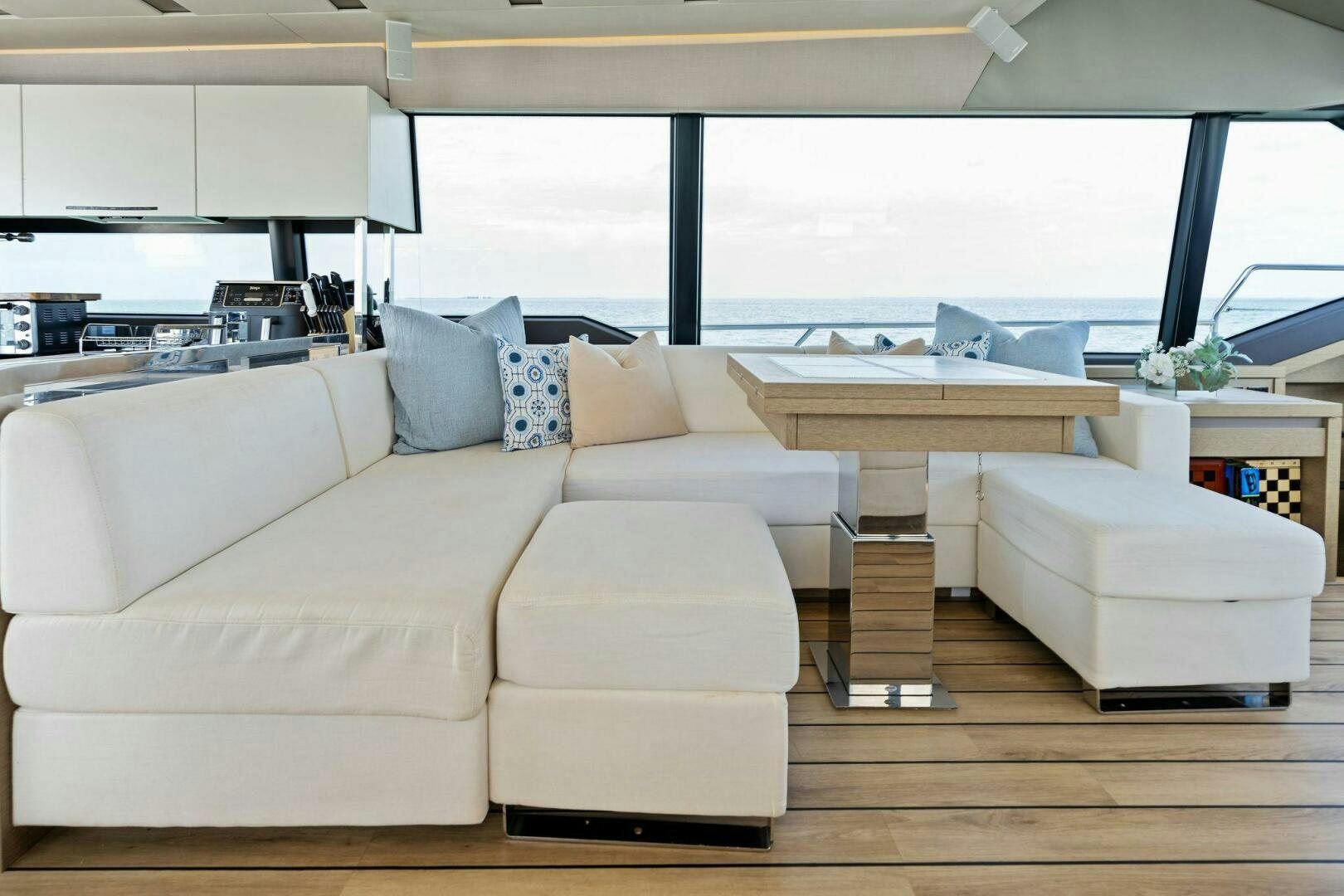 a living room with a couch and a table aboard PRESTIGE WORLDWIDE Yacht for Sale