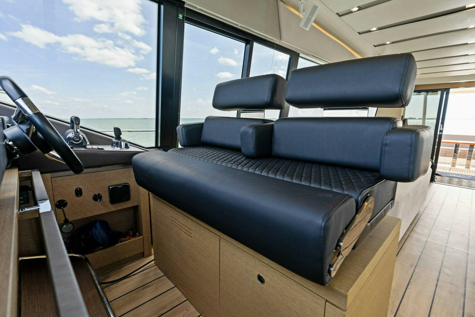 a room with a couch and a window aboard PRESTIGE WORLDWIDE Yacht for Sale