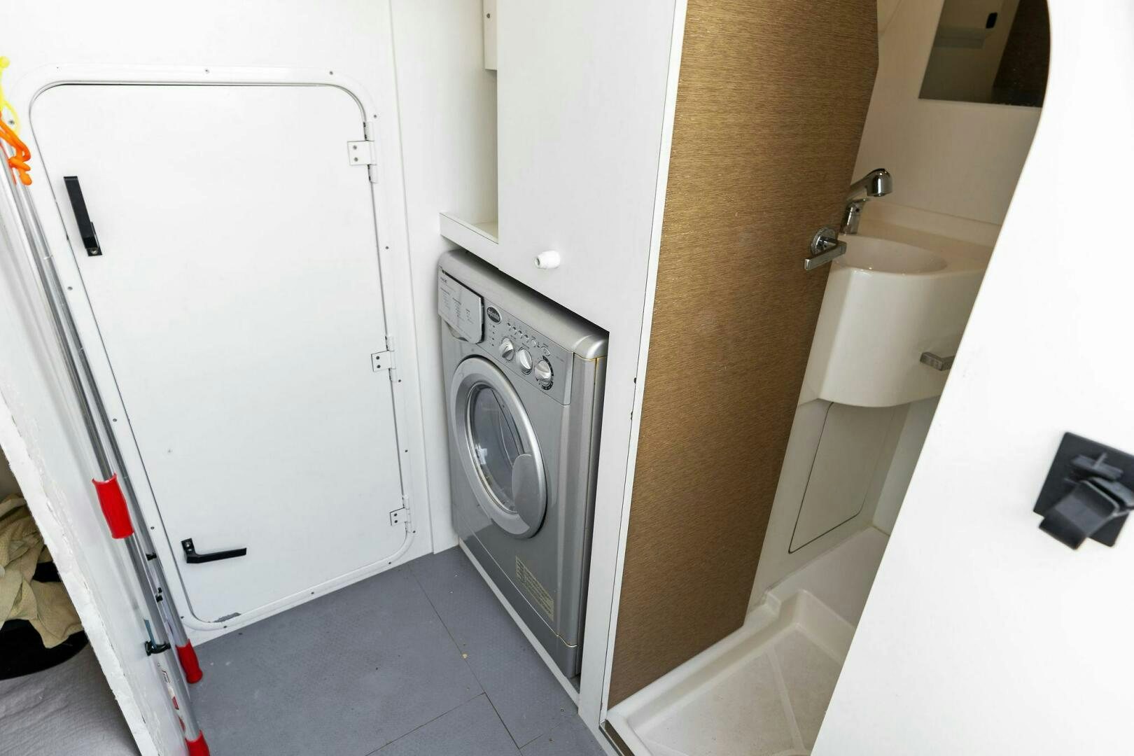 a washer and dryer in a bathroom aboard PRESTIGE WORLDWIDE Yacht for Sale