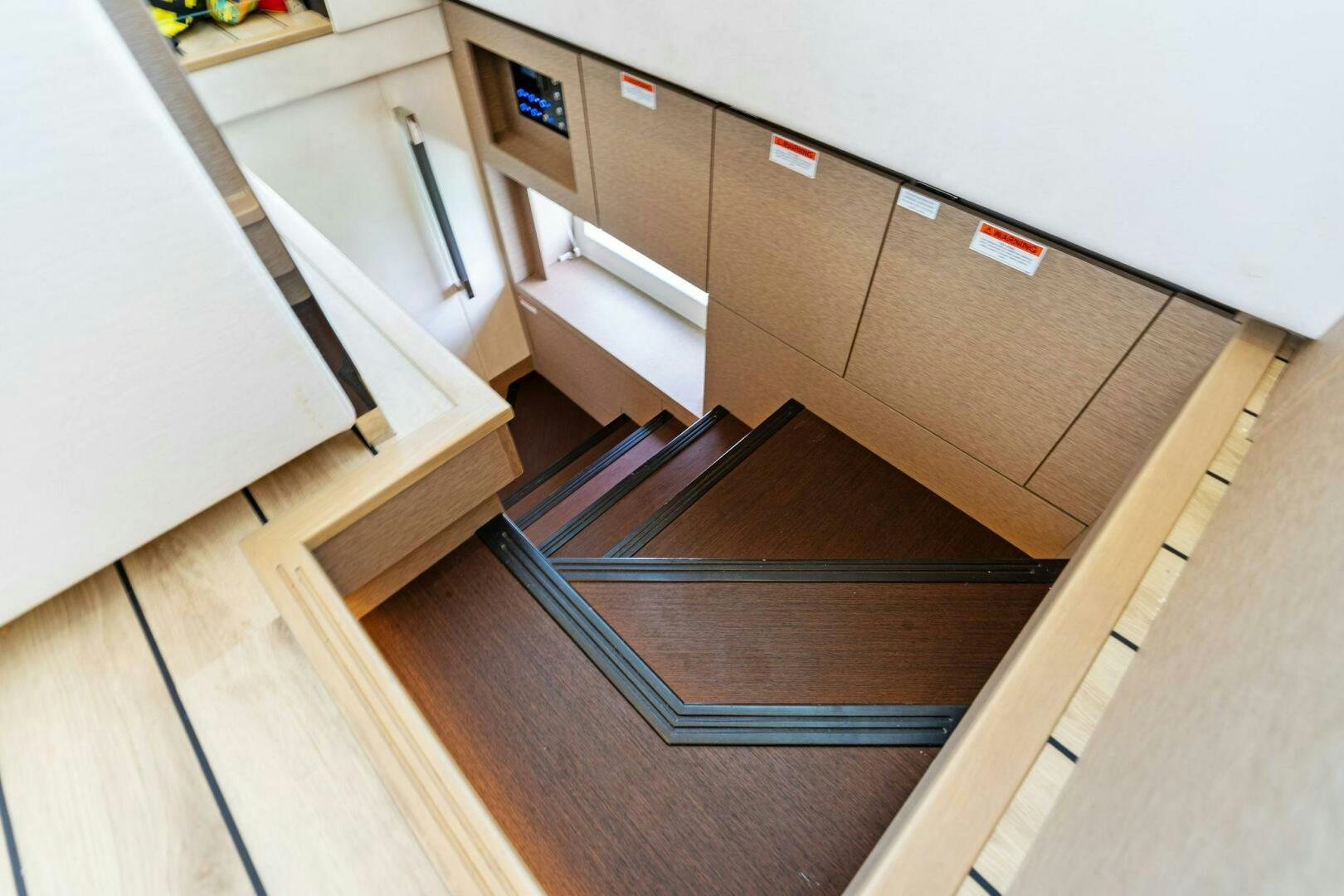 a wooden staircase in a room aboard PRESTIGE WORLDWIDE Yacht for Sale