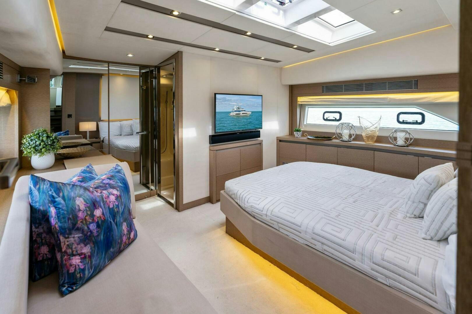 a bedroom with a bed and a tv on the wall aboard PRESTIGE WORLDWIDE Yacht for Sale