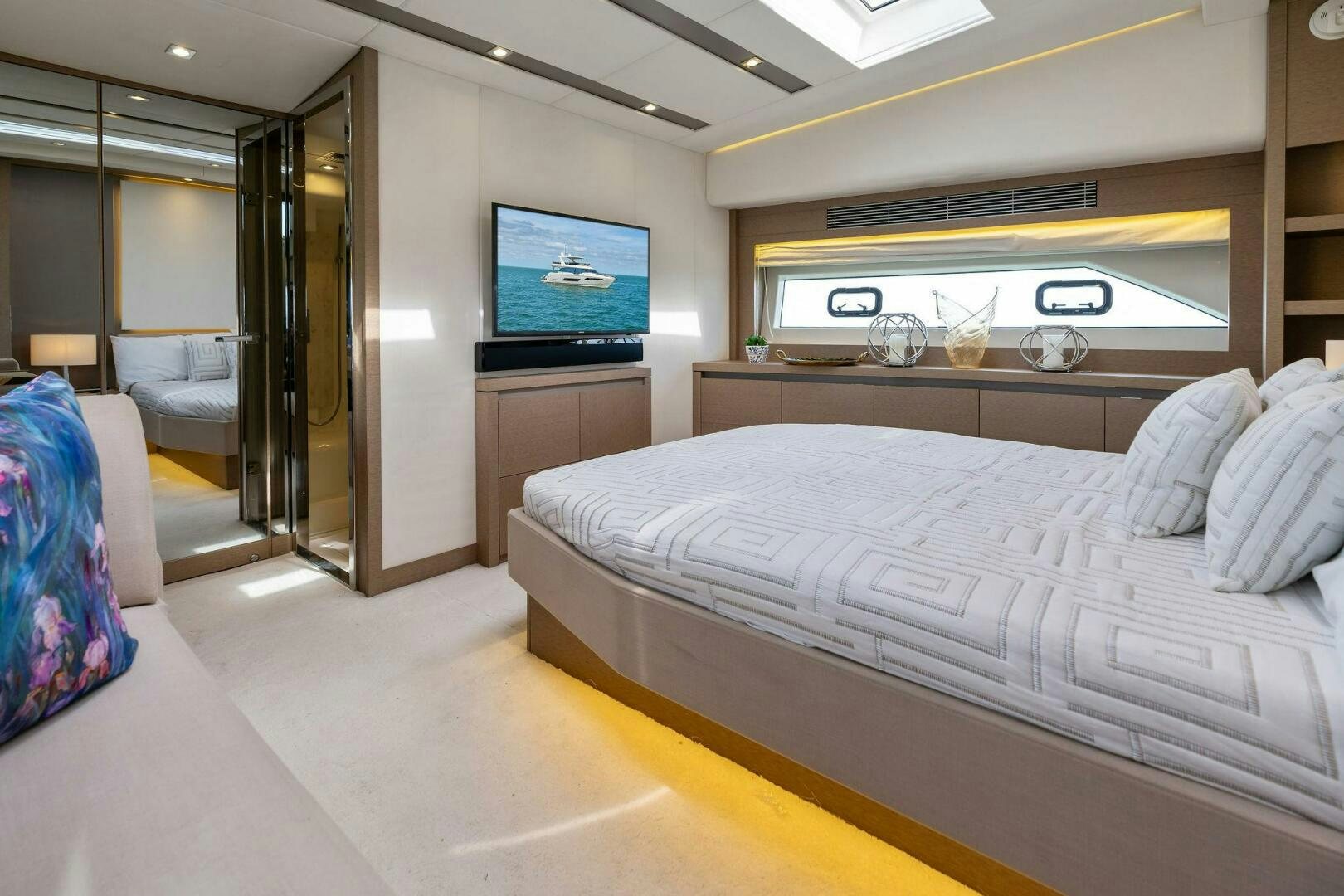 a bedroom with a bed and a tv on the wall aboard PRESTIGE WORLDWIDE Yacht for Sale