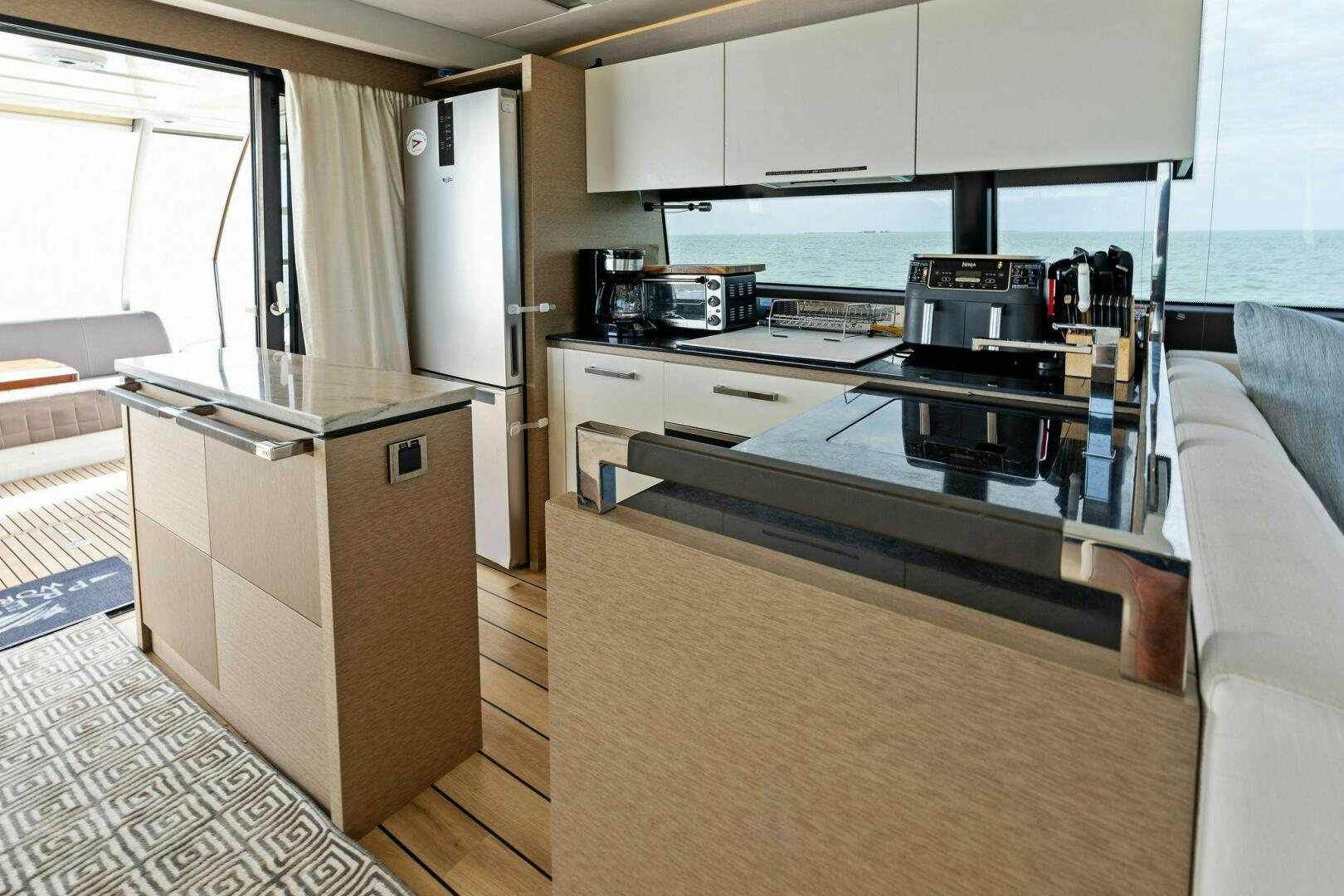 a kitchen with a stove and cabinets aboard PRESTIGE WORLDWIDE Yacht for Sale