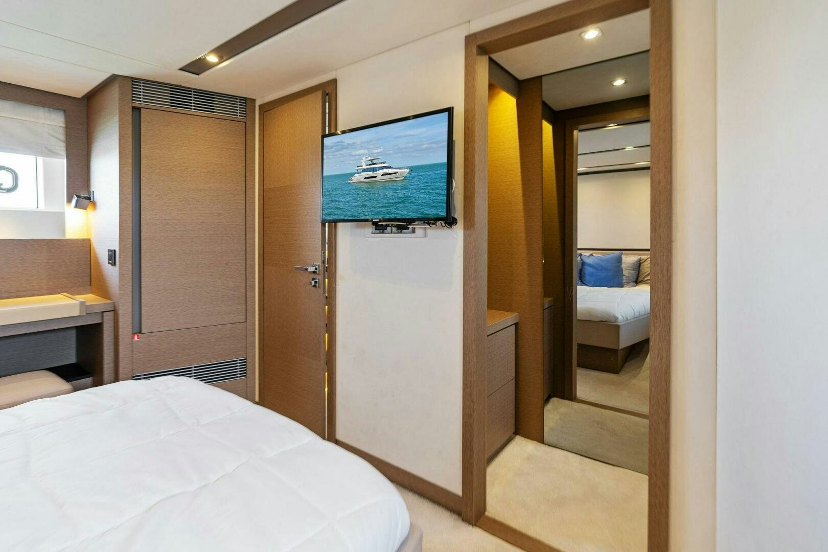 a hotel room with a tv on the wall aboard PRESTIGE WORLDWIDE Yacht for Sale