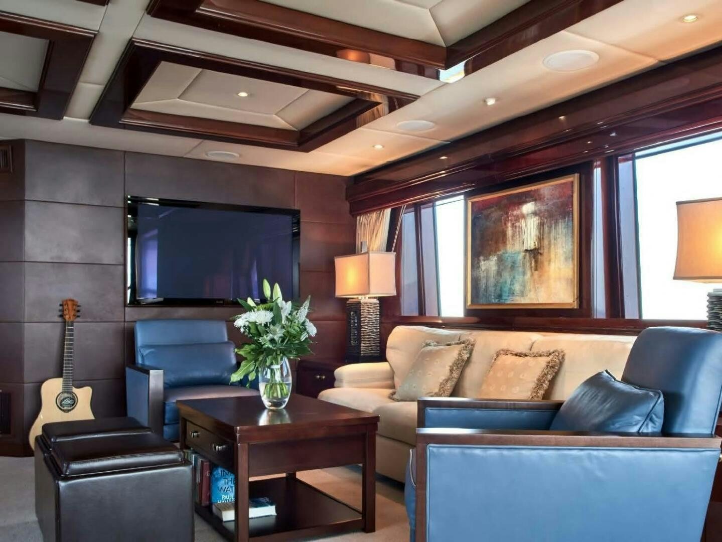 a living room with a couch and a guitar aboard REARDEN STEEL Yacht for Sale