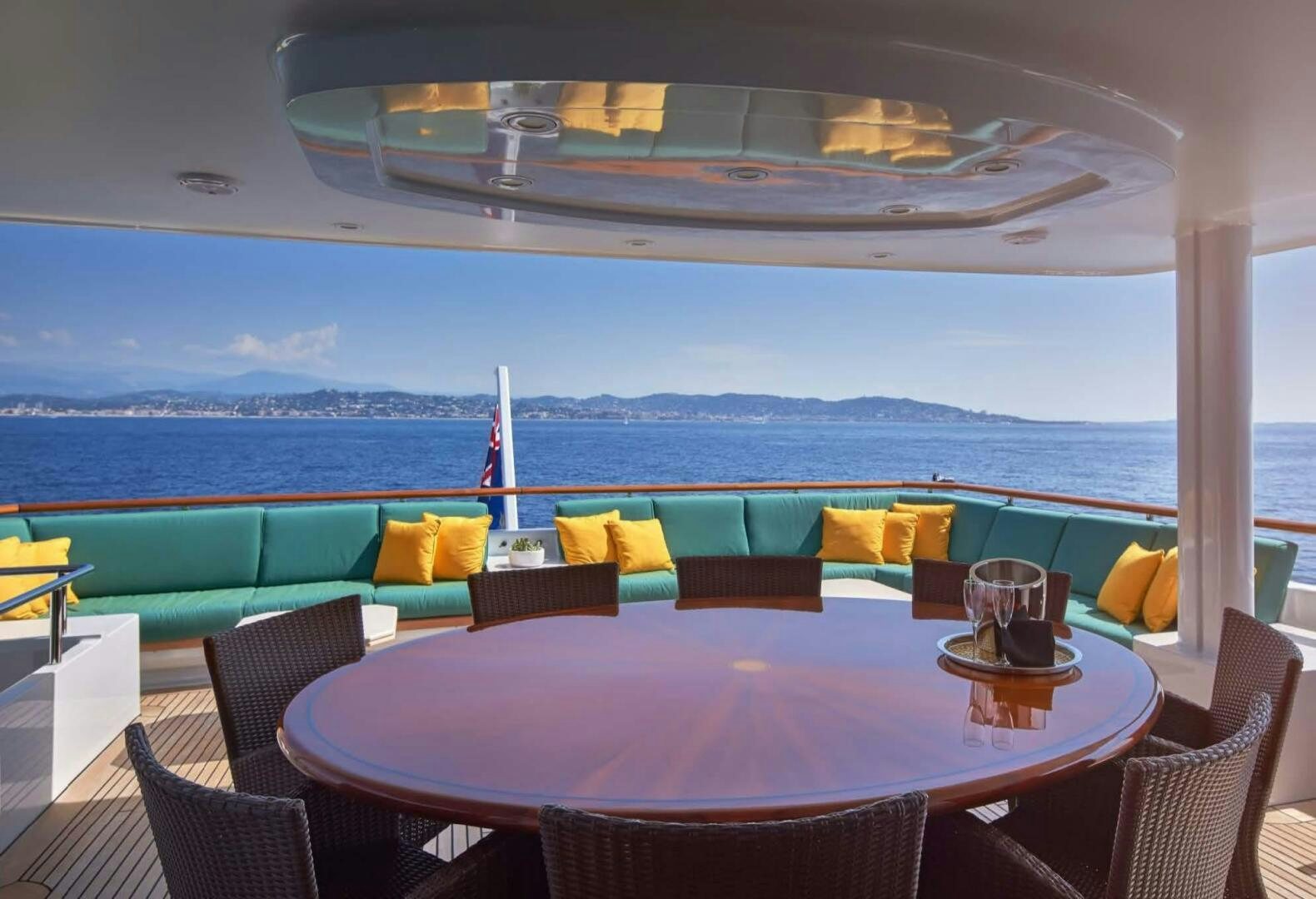 a table with chairs and a view of the ocean aboard REARDEN STEEL Yacht for Sale