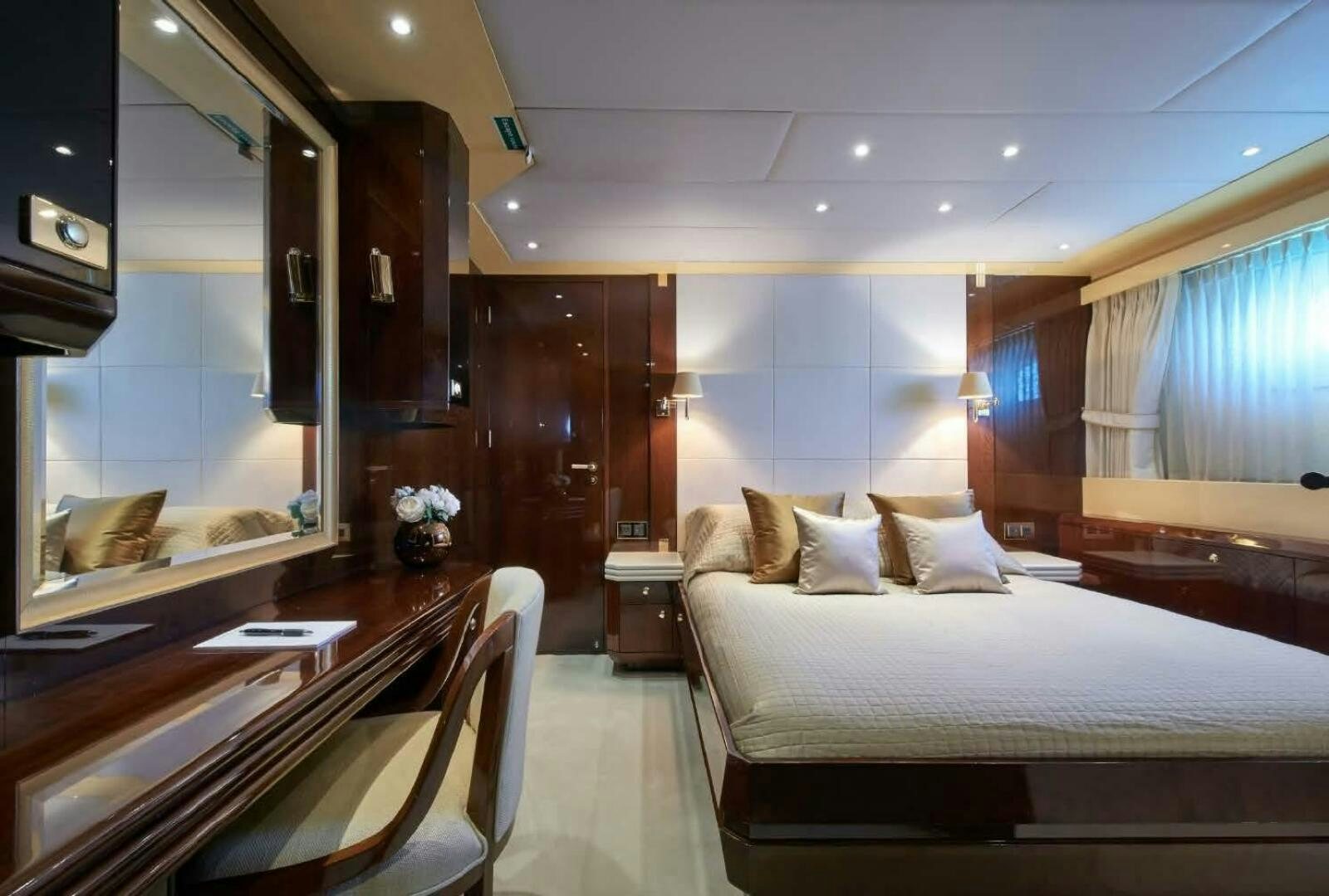 a room with a bed and a desk aboard REARDEN STEEL Yacht for Sale