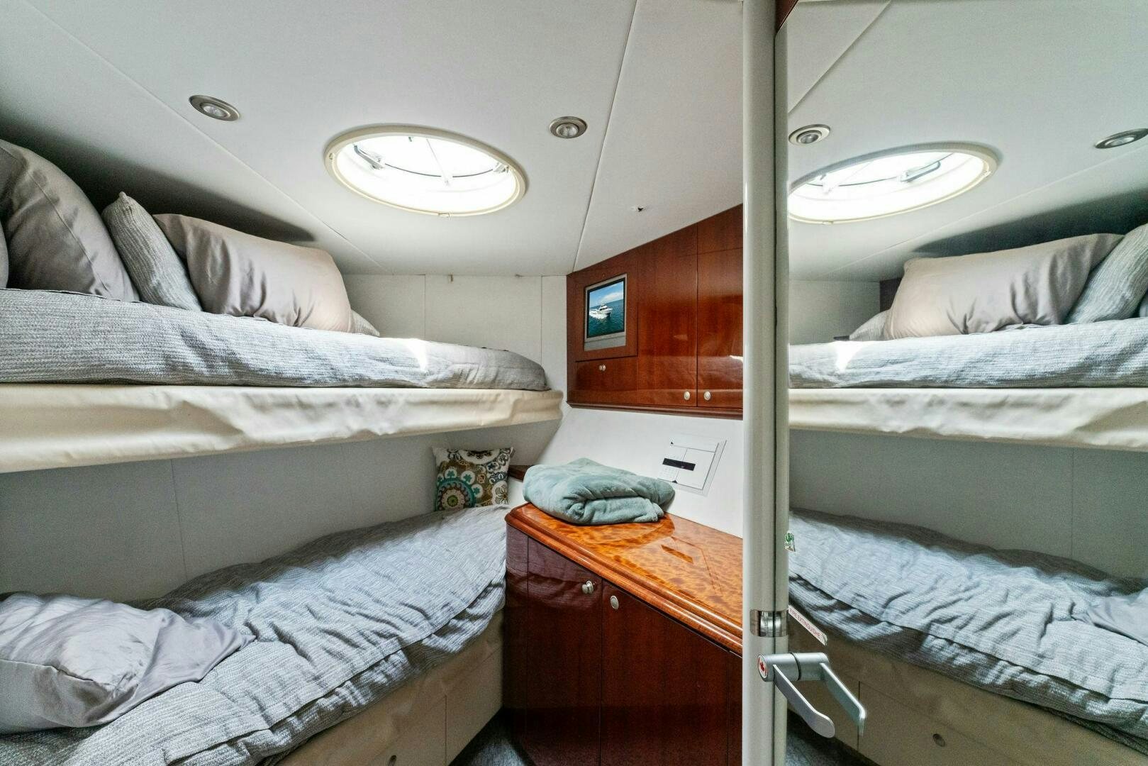 a room with beds and a window aboard CORAGGIO Yacht for Sale