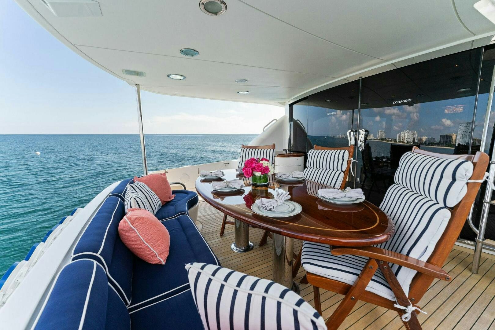 a boat with a table and chairs on the deck aboard CORAGGIO Yacht for Sale