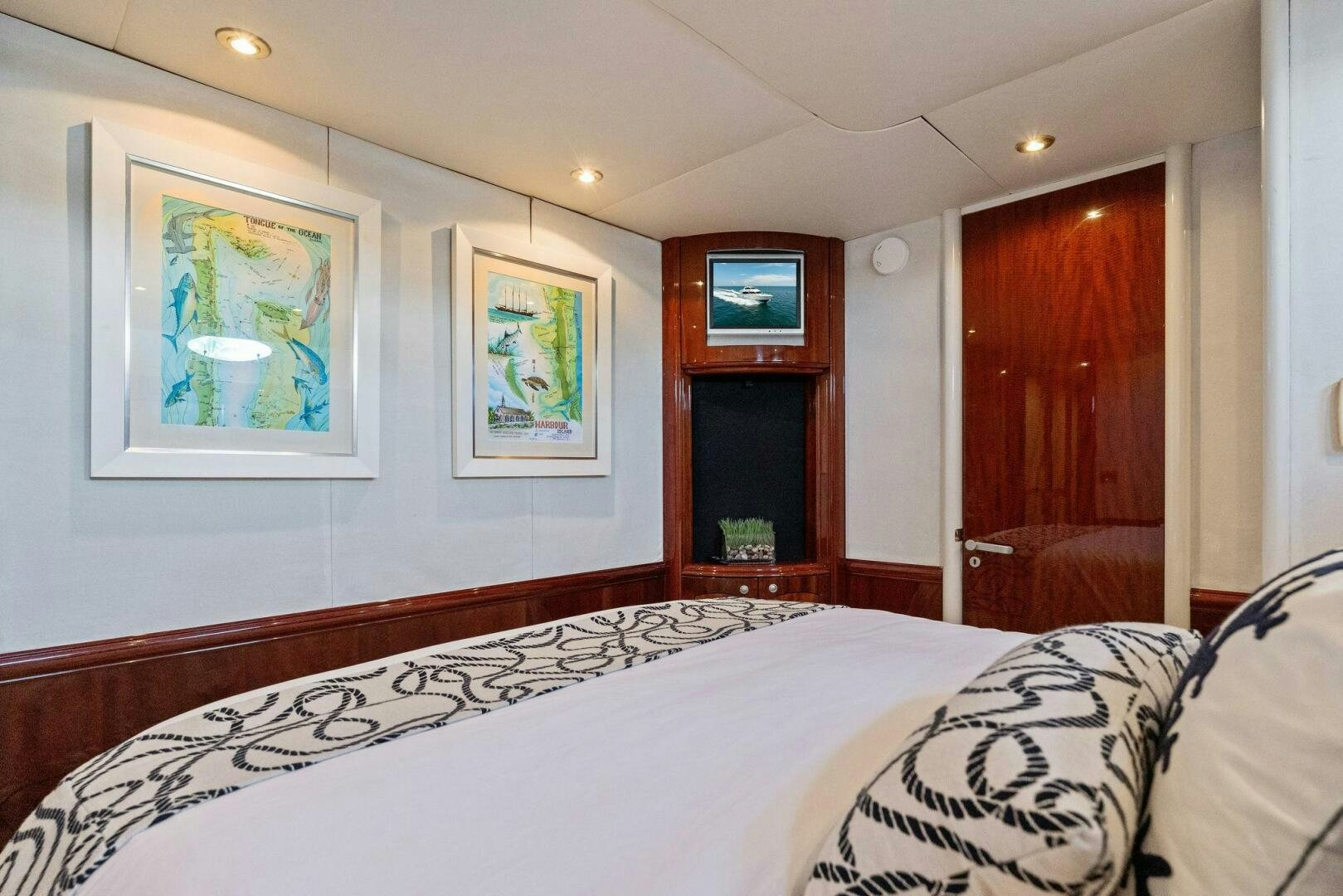 a bedroom with a bed and a mirror aboard CORAGGIO Yacht for Sale