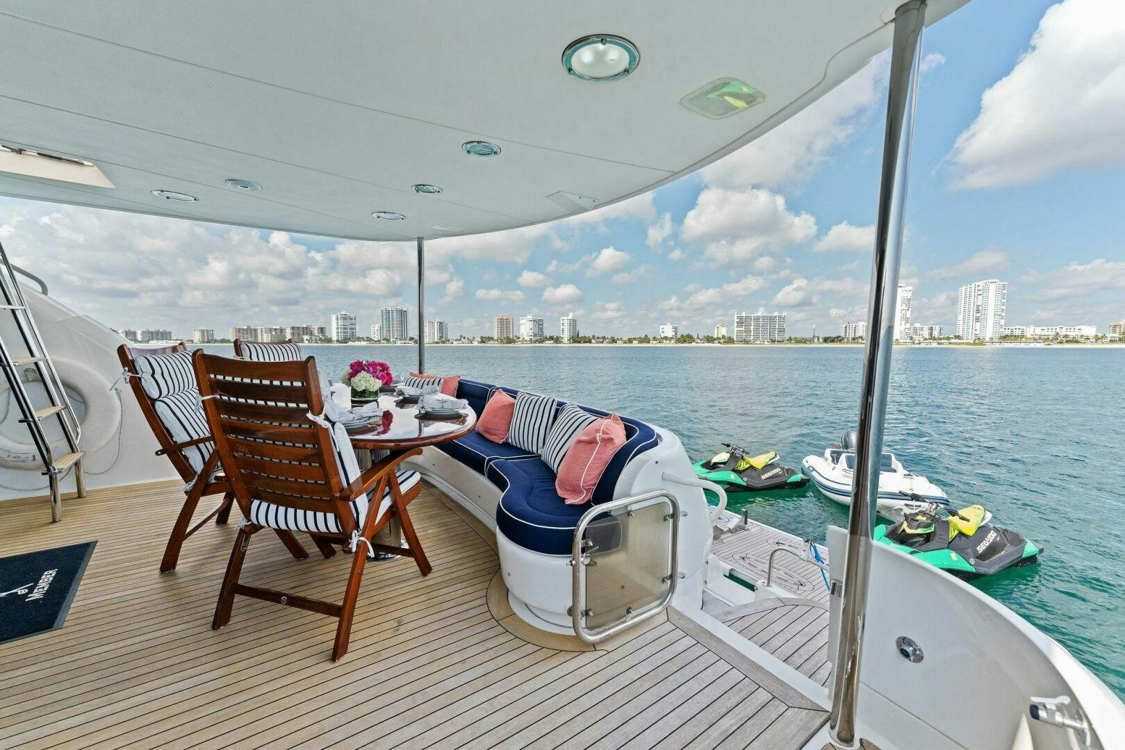 a room with a table chairs and a view of the city aboard CORAGGIO Yacht for Sale