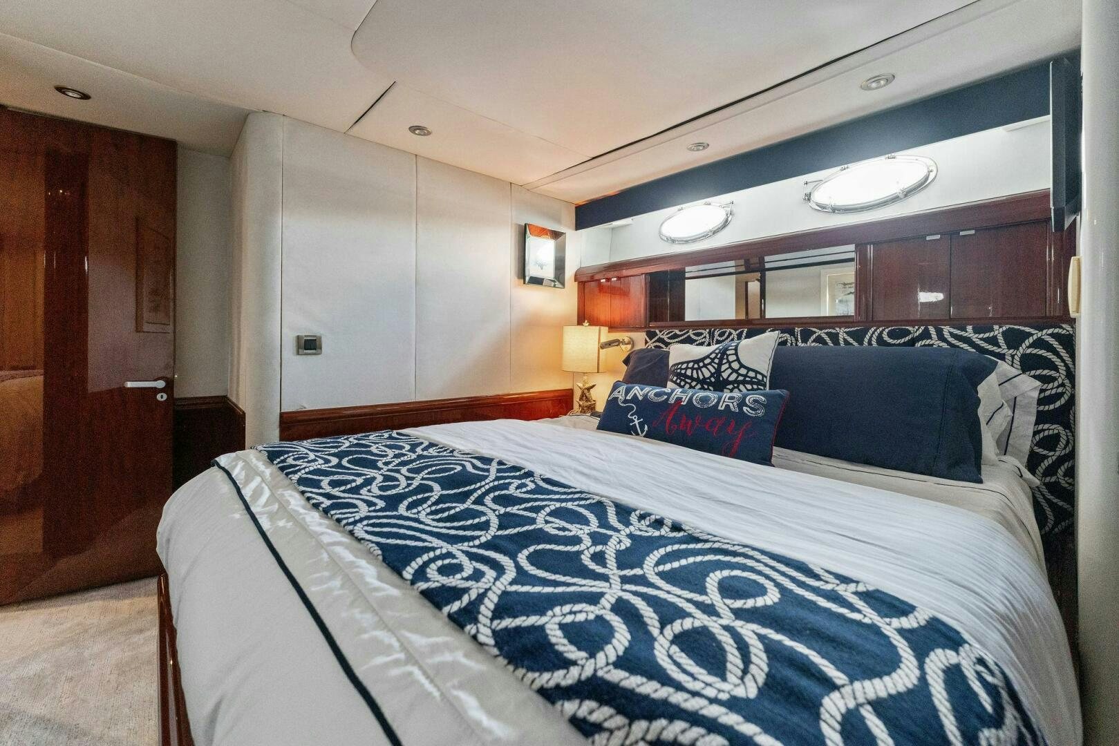 a bed with blue and white sheets aboard CORAGGIO Yacht for Sale