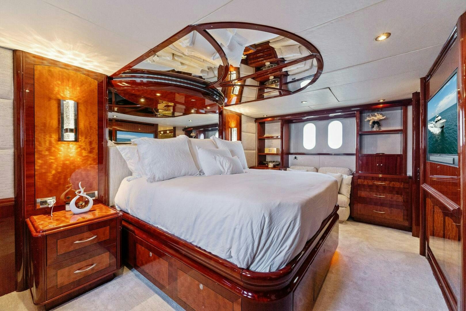 a bedroom with a bed and a dresser aboard CORAGGIO Yacht for Sale