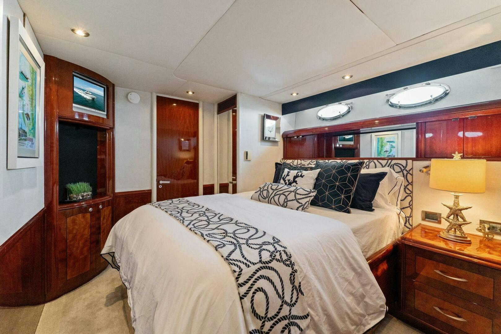 a bedroom with a bed and a desk aboard CORAGGIO Yacht for Sale