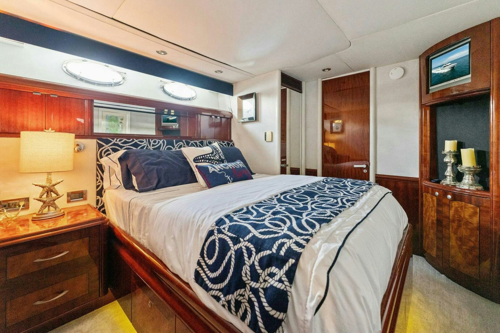 a bedroom with a bed and a desk aboard CORAGGIO Yacht for Sale
