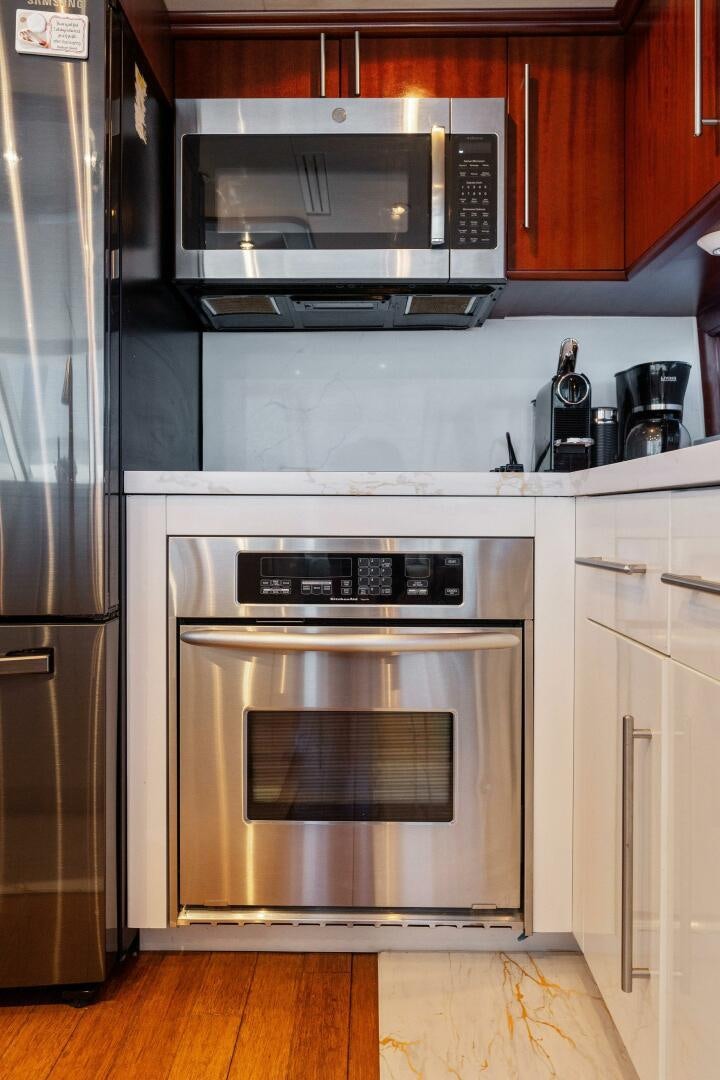 a kitchen with a stainless steel oven aboard CORAGGIO Yacht for Sale