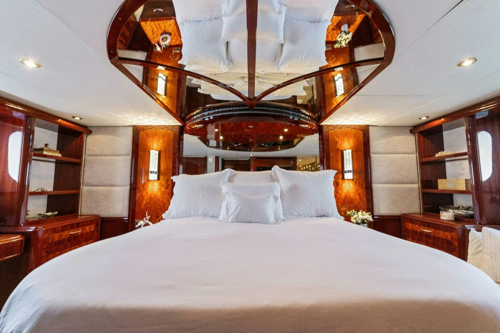 a bed with white sheets and pillows aboard CORAGGIO Yacht for Sale