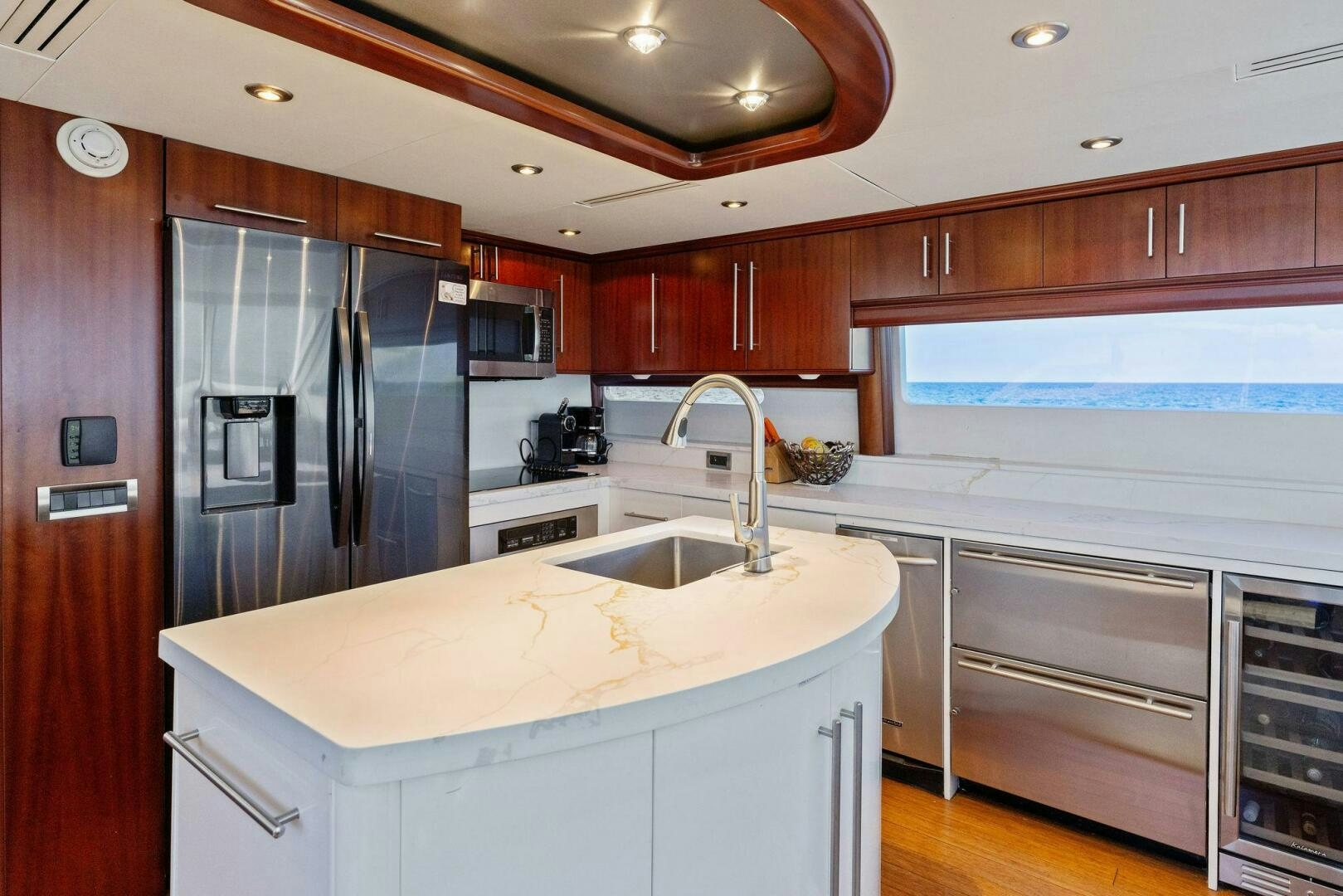 a kitchen with a sink and refrigerator aboard CORAGGIO Yacht for Sale