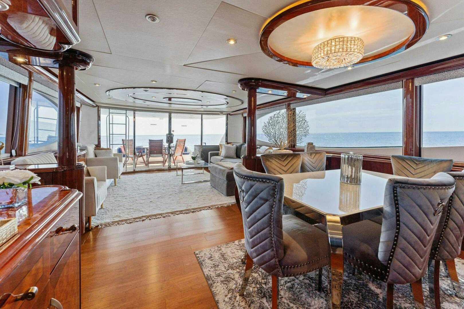 a large dining room with a large chandelier aboard CORAGGIO Yacht for Sale