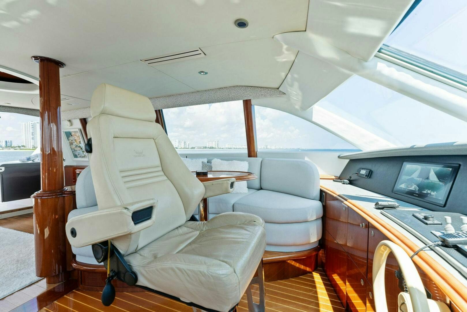 inside of a vehicle with a television and a table and chairs aboard CORAGGIO Yacht for Sale