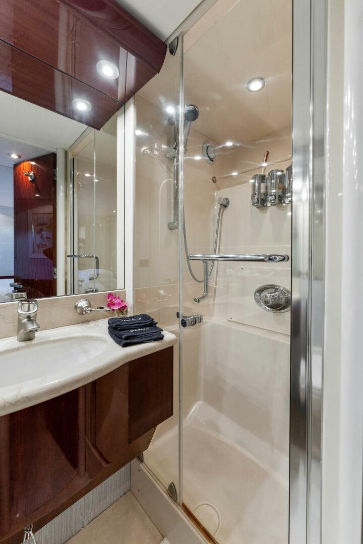 a bathroom with a glass shower aboard CORAGGIO Yacht for Sale