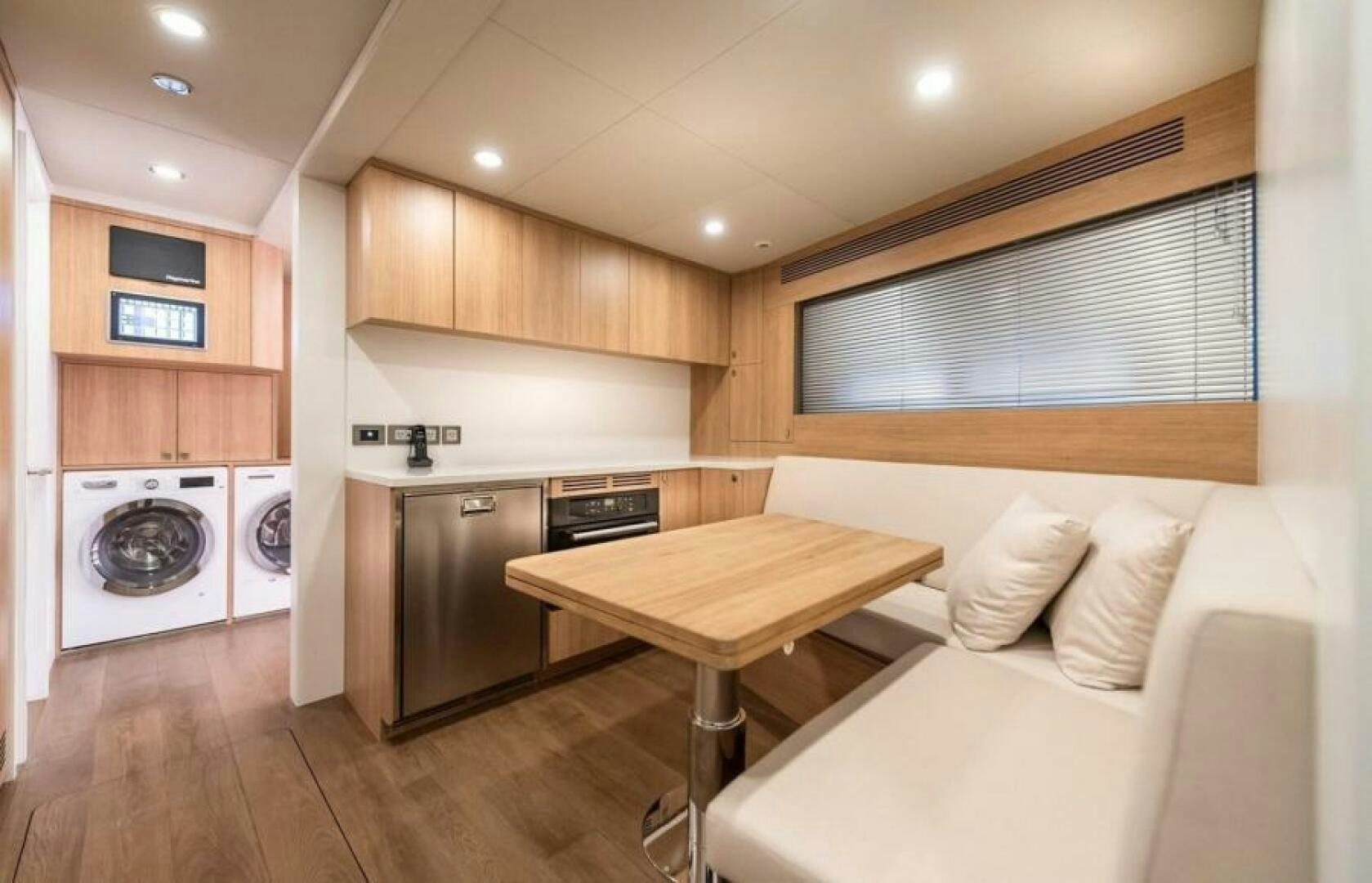 a kitchen with a table and a couch aboard NUMARINE 32XP HULL 6 Yacht for Sale