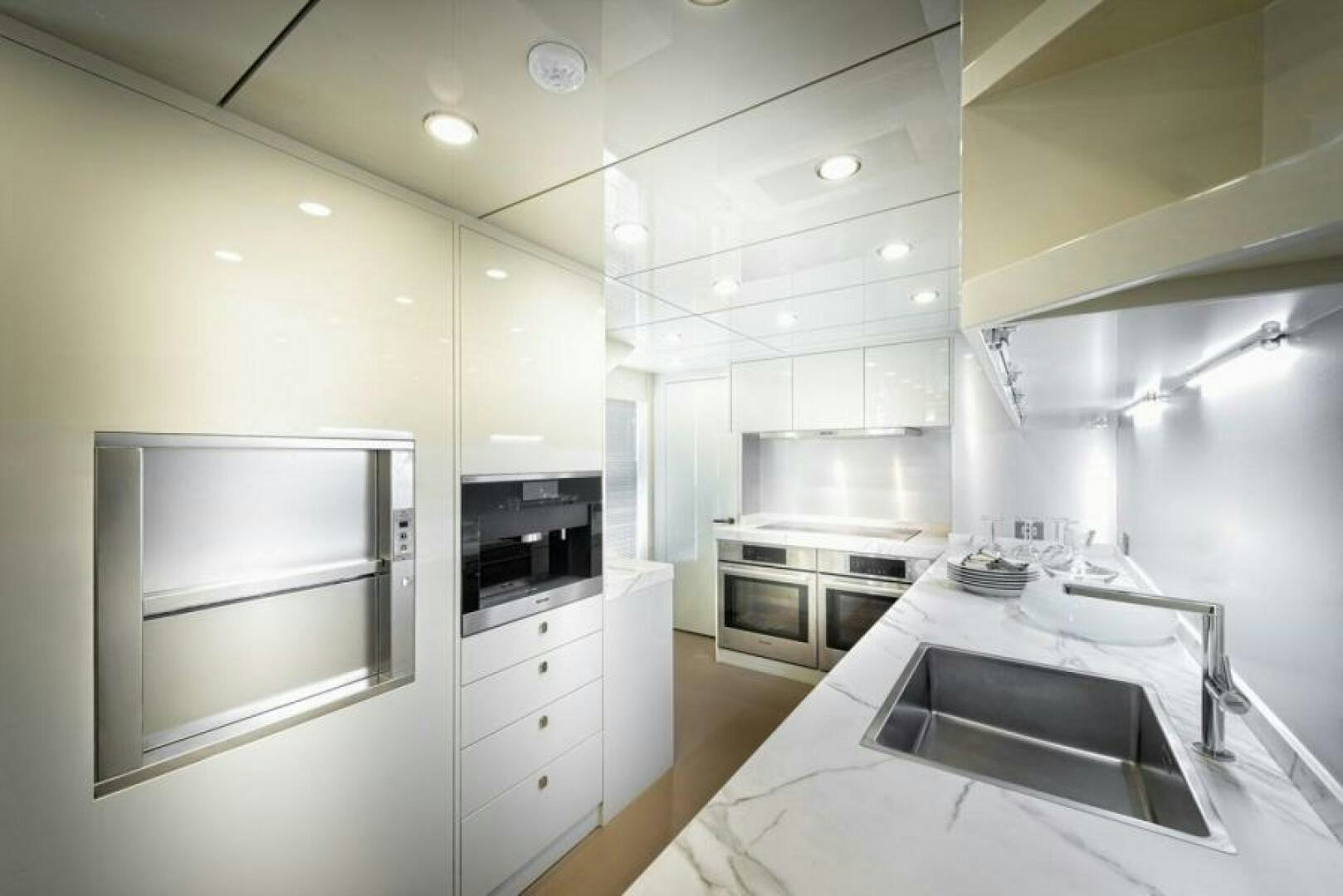 a kitchen with white cabinets aboard NUMARINE 32XP HULL 6 Yacht for Sale