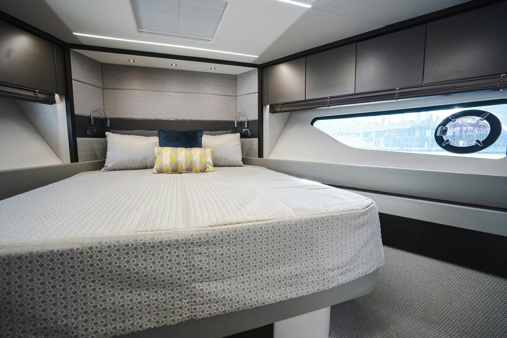 a bed with a white sheet and pillows on it aboard INCENTIVIZED Yacht for Sale