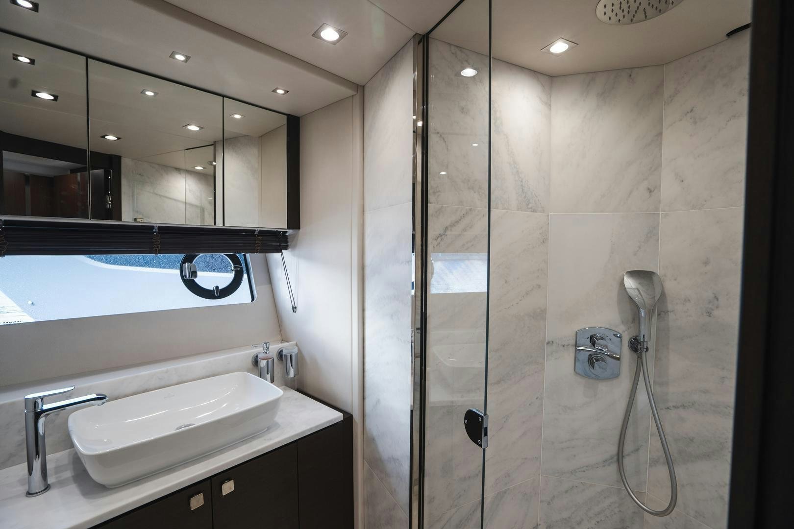 a bathroom with a glass shower aboard INCENTIVIZED Yacht for Sale