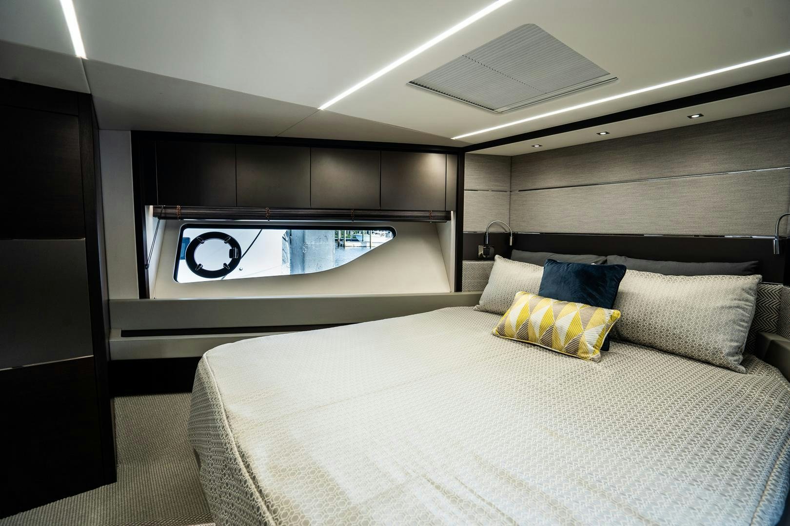 a room with a bed and a large window aboard INCENTIVIZED Yacht for Sale