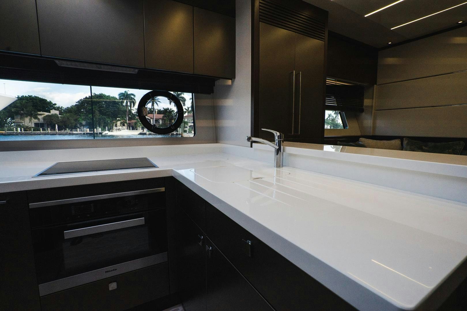 a kitchen with a large black clock aboard INCENTIVIZED Yacht for Sale
