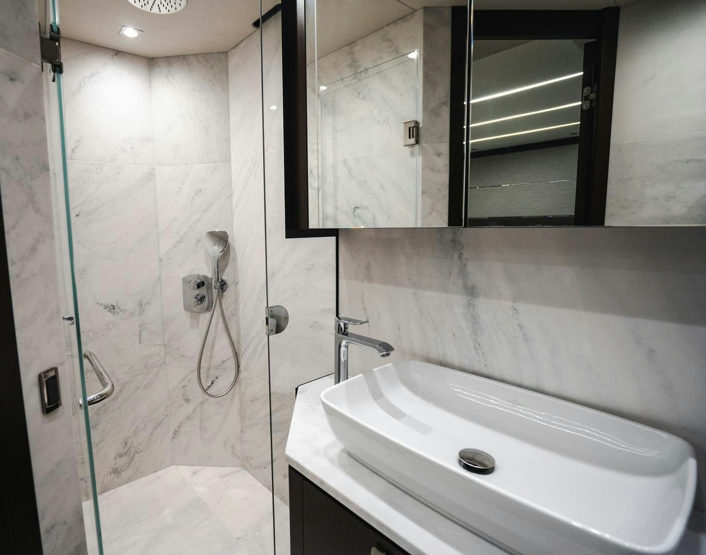 a bathroom with a sink and a mirror aboard INCENTIVIZED Yacht for Sale