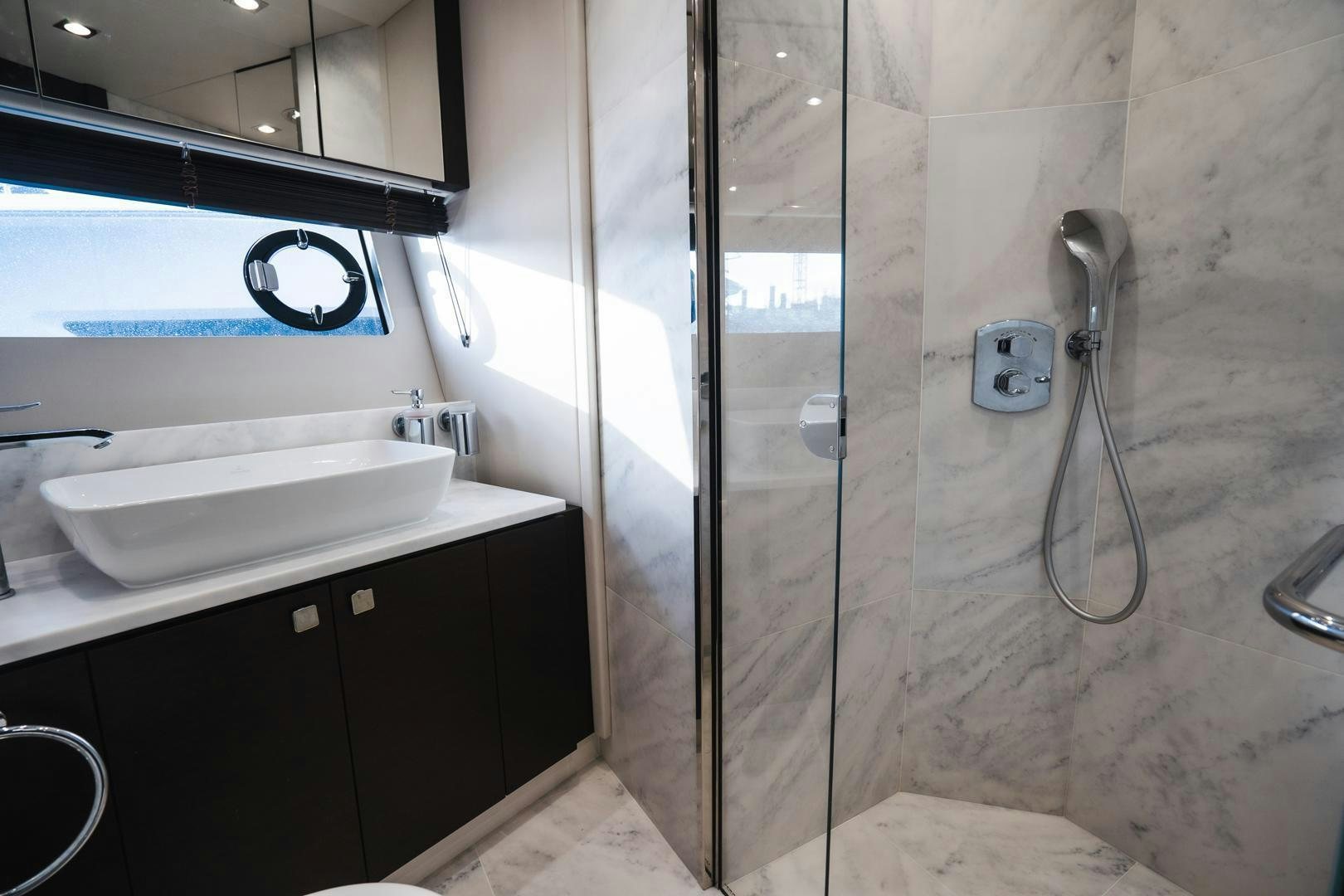 a bathroom with a shower unit and sink aboard INCENTIVIZED Yacht for Sale