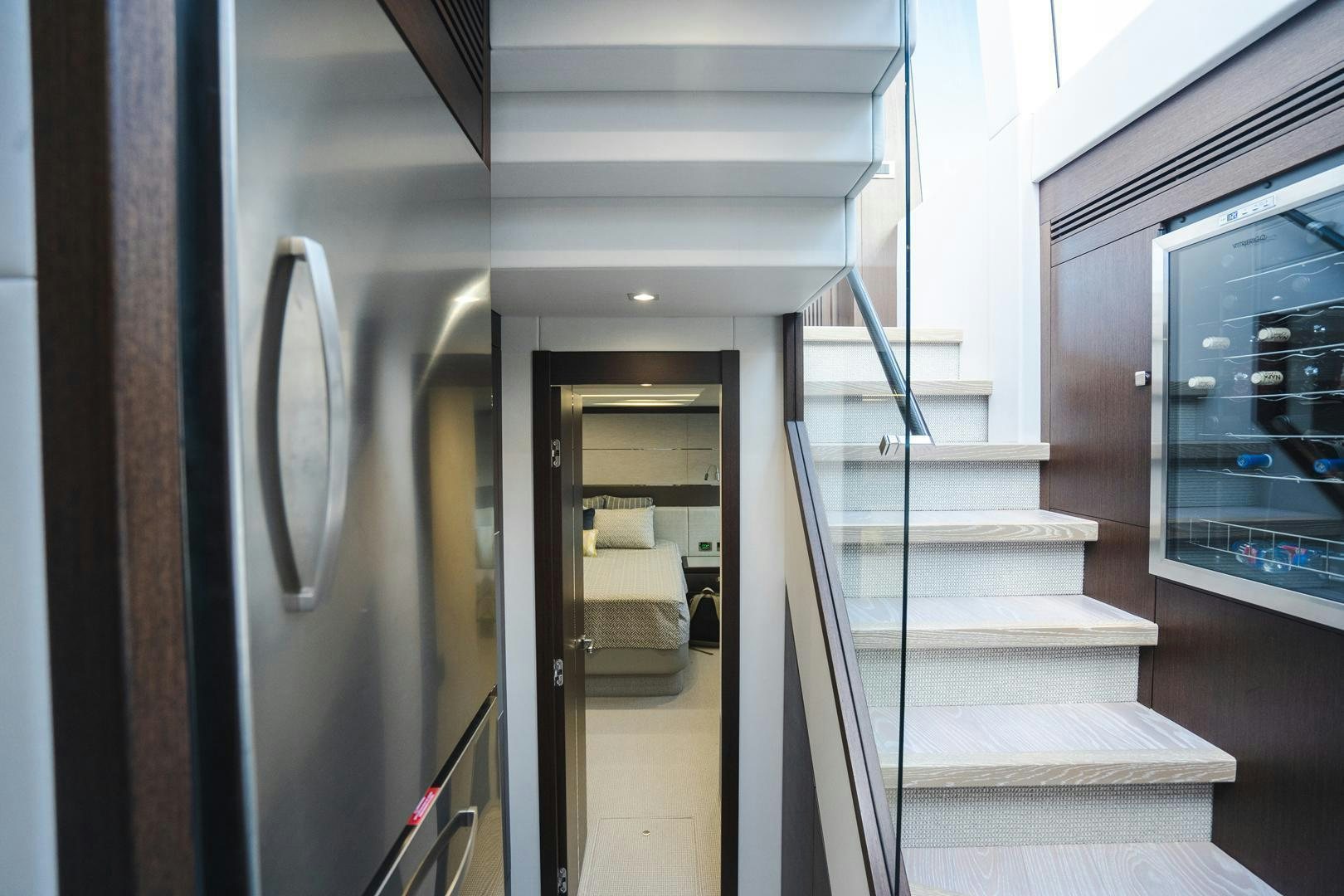 a hallway with a door and a staircase aboard INCENTIVIZED Yacht for Sale
