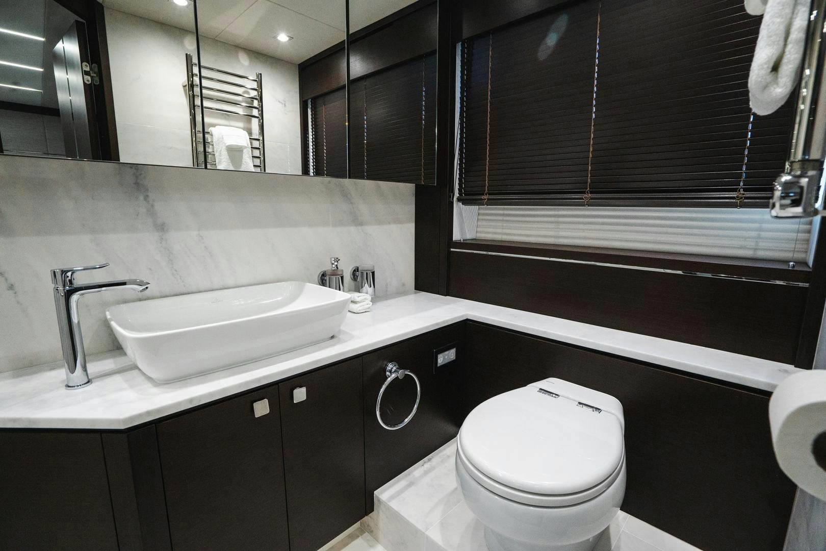 a bathroom with a sink and a toilet aboard INCENTIVIZED Yacht for Sale