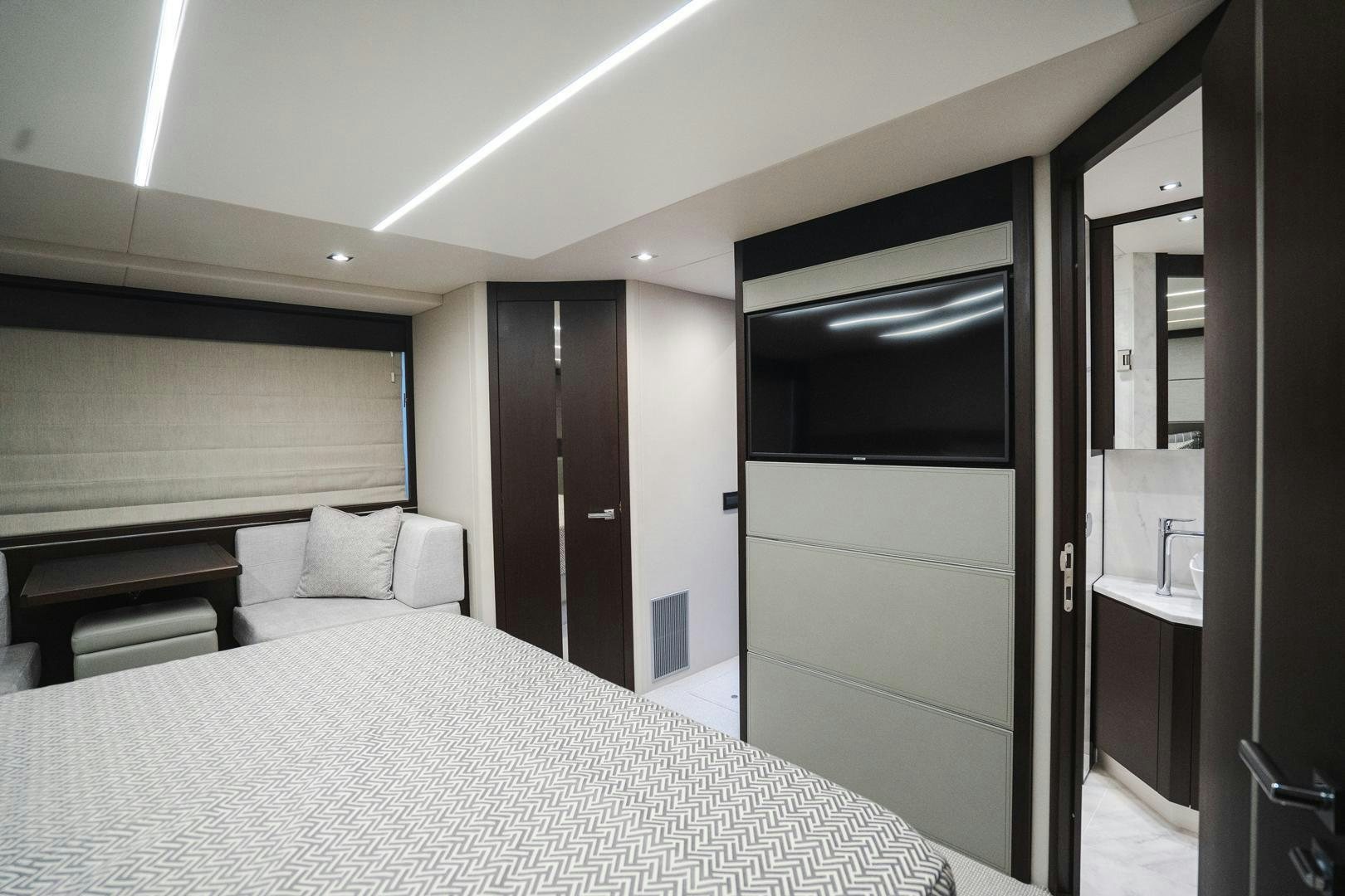 a bedroom with a bed and a mirror aboard INCENTIVIZED Yacht for Sale