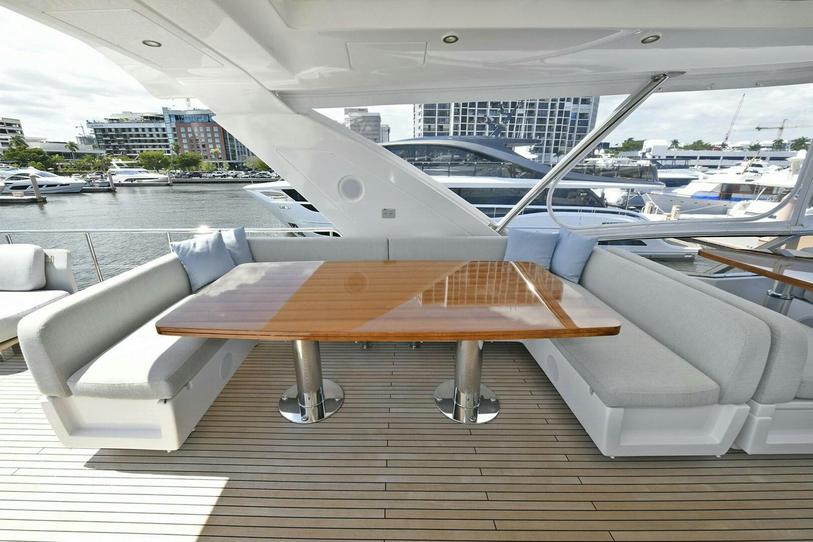 a deck with a large boat on it and a body of water in the background aboard SLAINTE Yacht for Sale