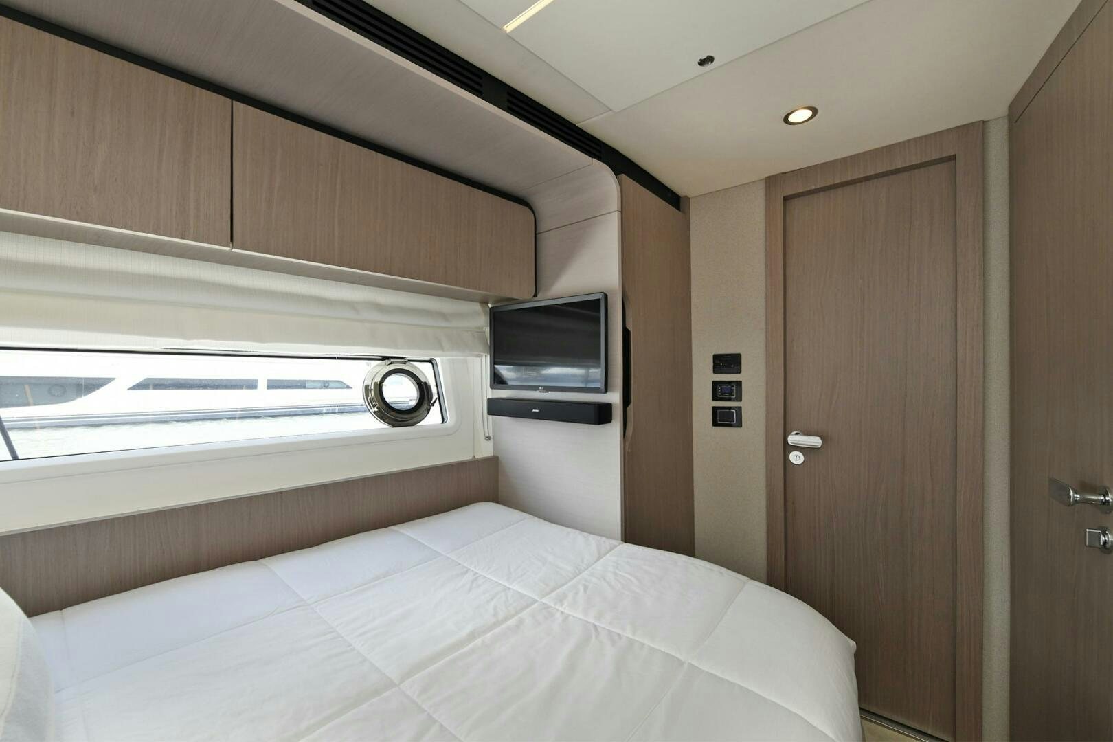a room with a bed and a television aboard SLAINTE Yacht for Sale