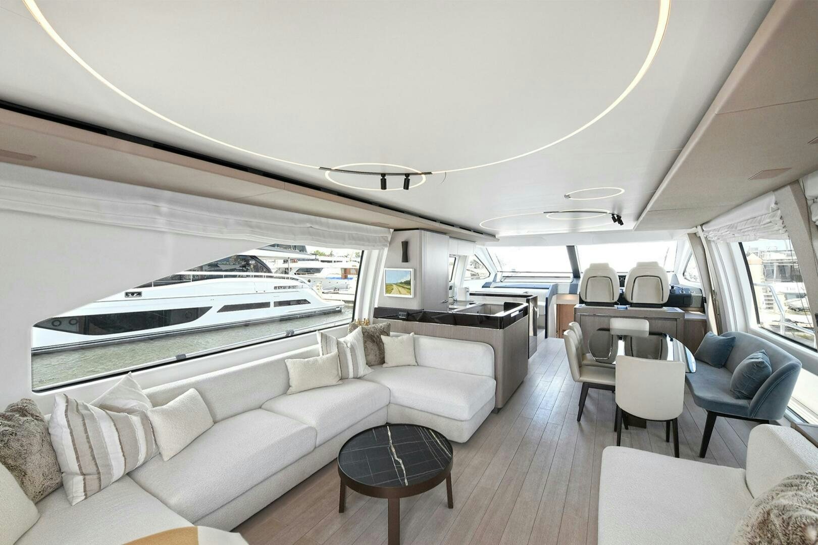 a room with a couch and a table and a large window aboard SLAINTE Yacht for Sale
