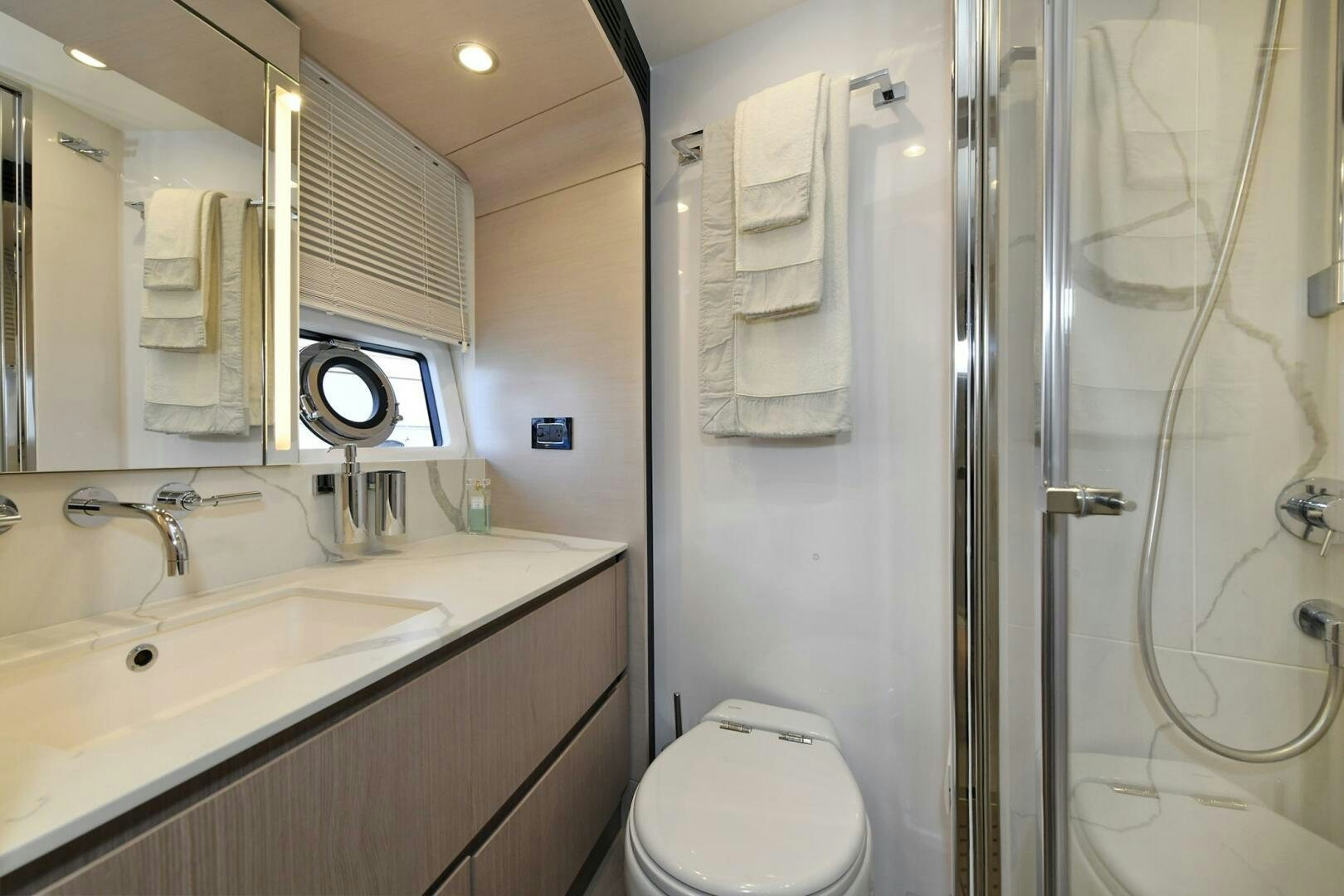 a bathroom with a shower and sink aboard SLAINTE Yacht for Sale