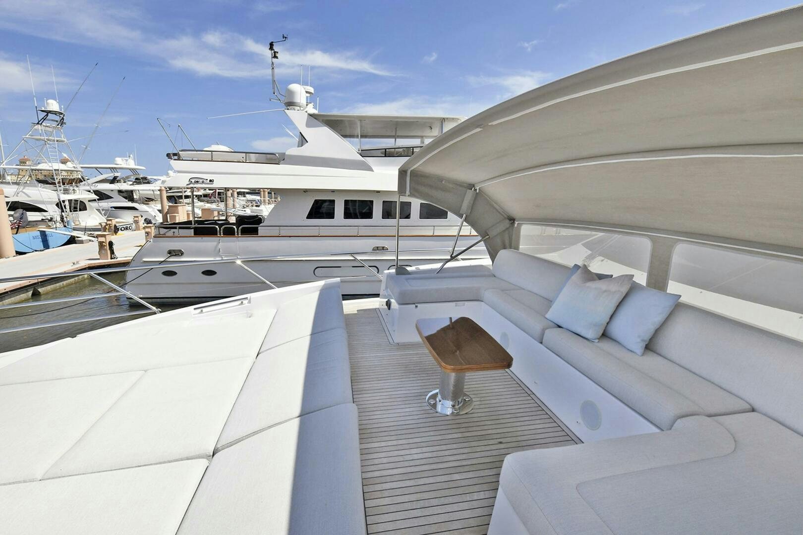 a deck with a view of a marina and boats aboard SLAINTE Yacht for Sale
